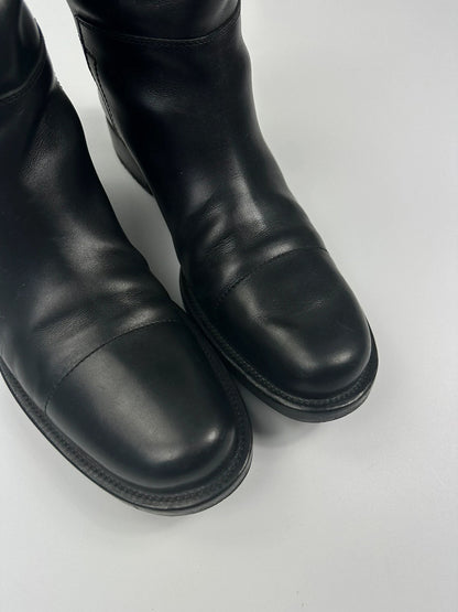 Prada black leather ankle boots with round toe and subtle logo detailing.