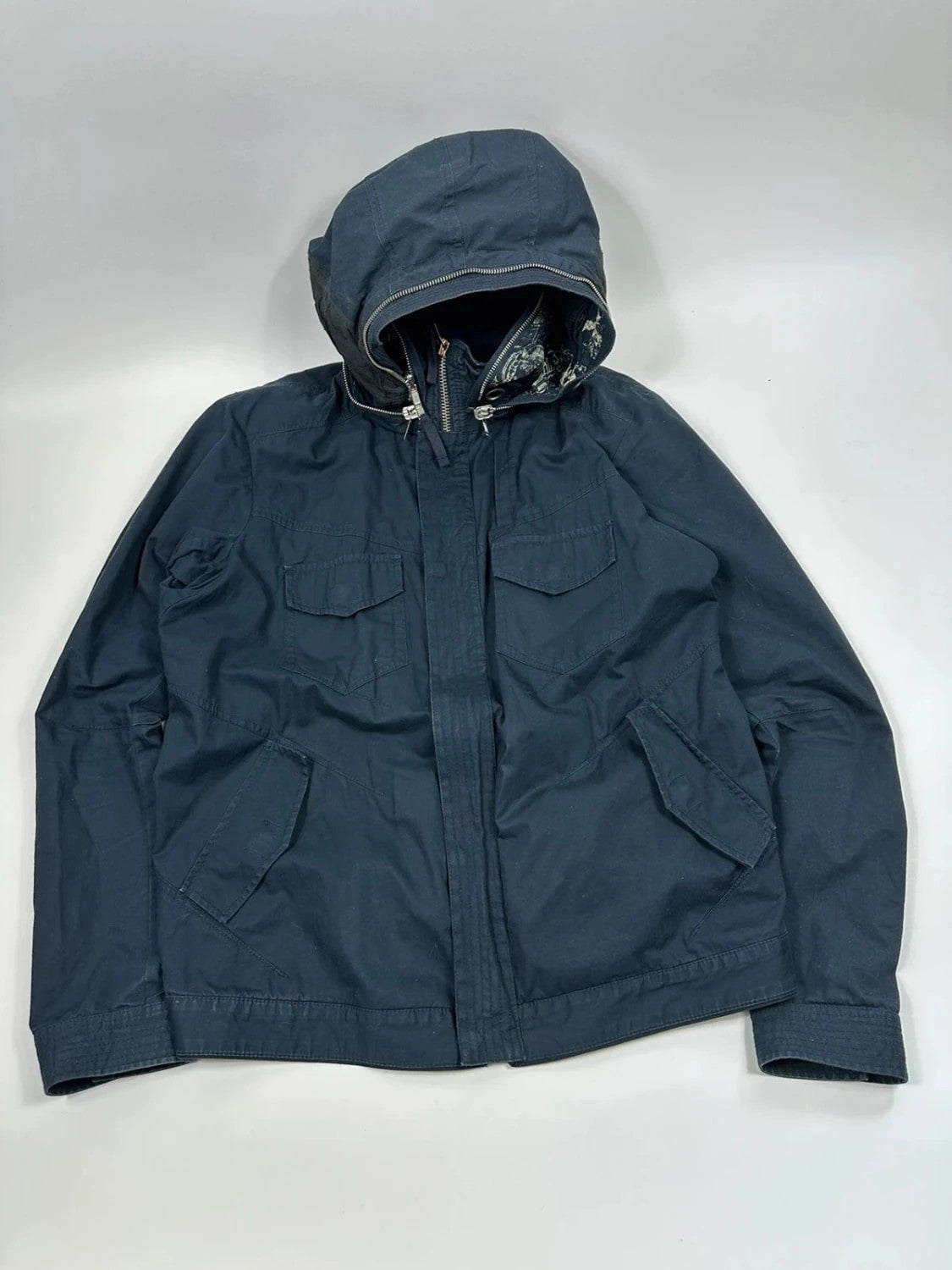 Marithé Francois Girbaud navy multi-pocket jacket adjustable fit packable design.
