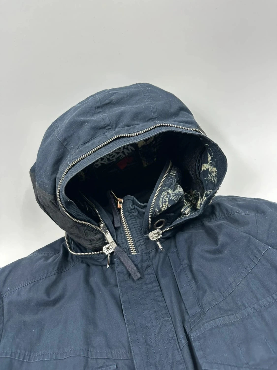 Marithé Francois Girbaud navy multi-pocket jacket adjustable fit packable design.