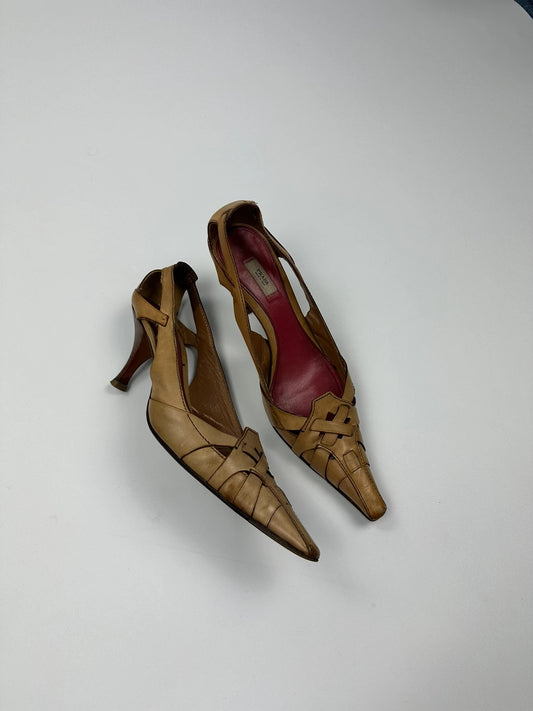 Prada beige leather pumps with pointy toe and subtle logo detailing.