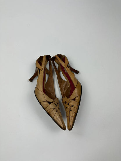 Prada beige leather pumps with pointy toe and subtle logo detailing.