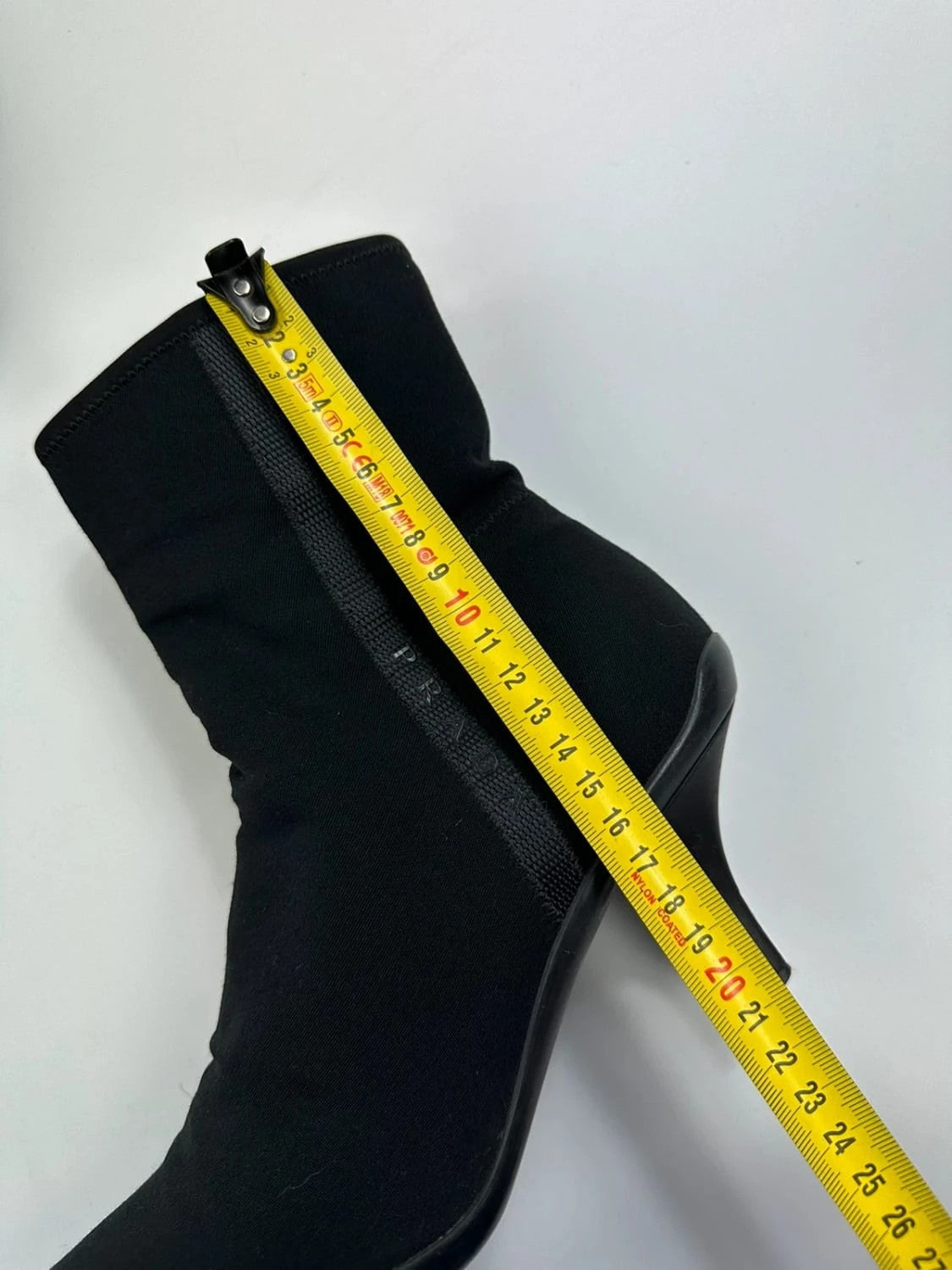 Prada black neoprene boots with pointed toe and leather interior.