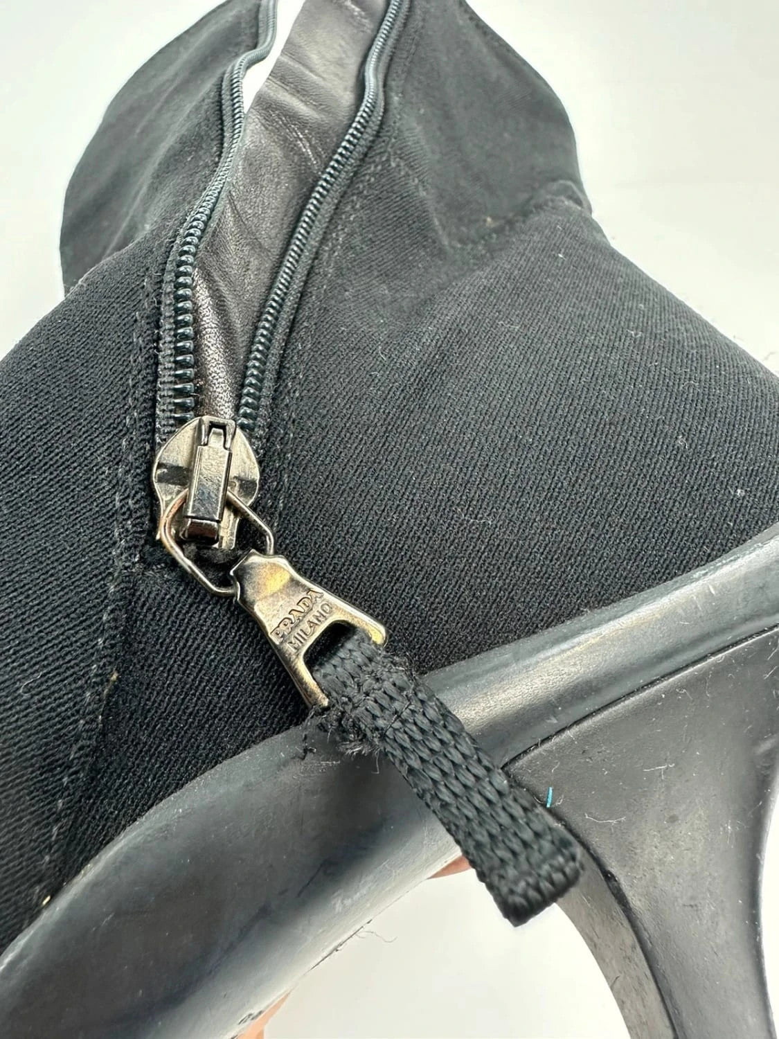 Prada black neoprene boots with pointed toe and leather interior.