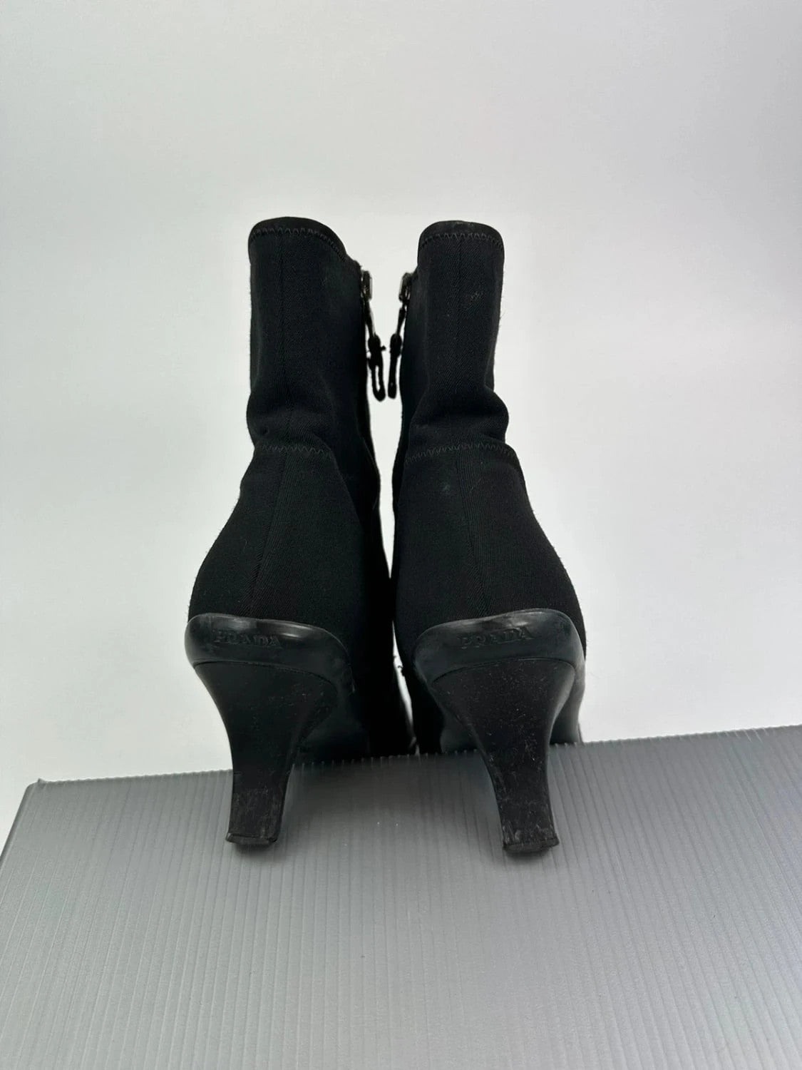 Prada black neoprene boots with pointed toe and leather interior.