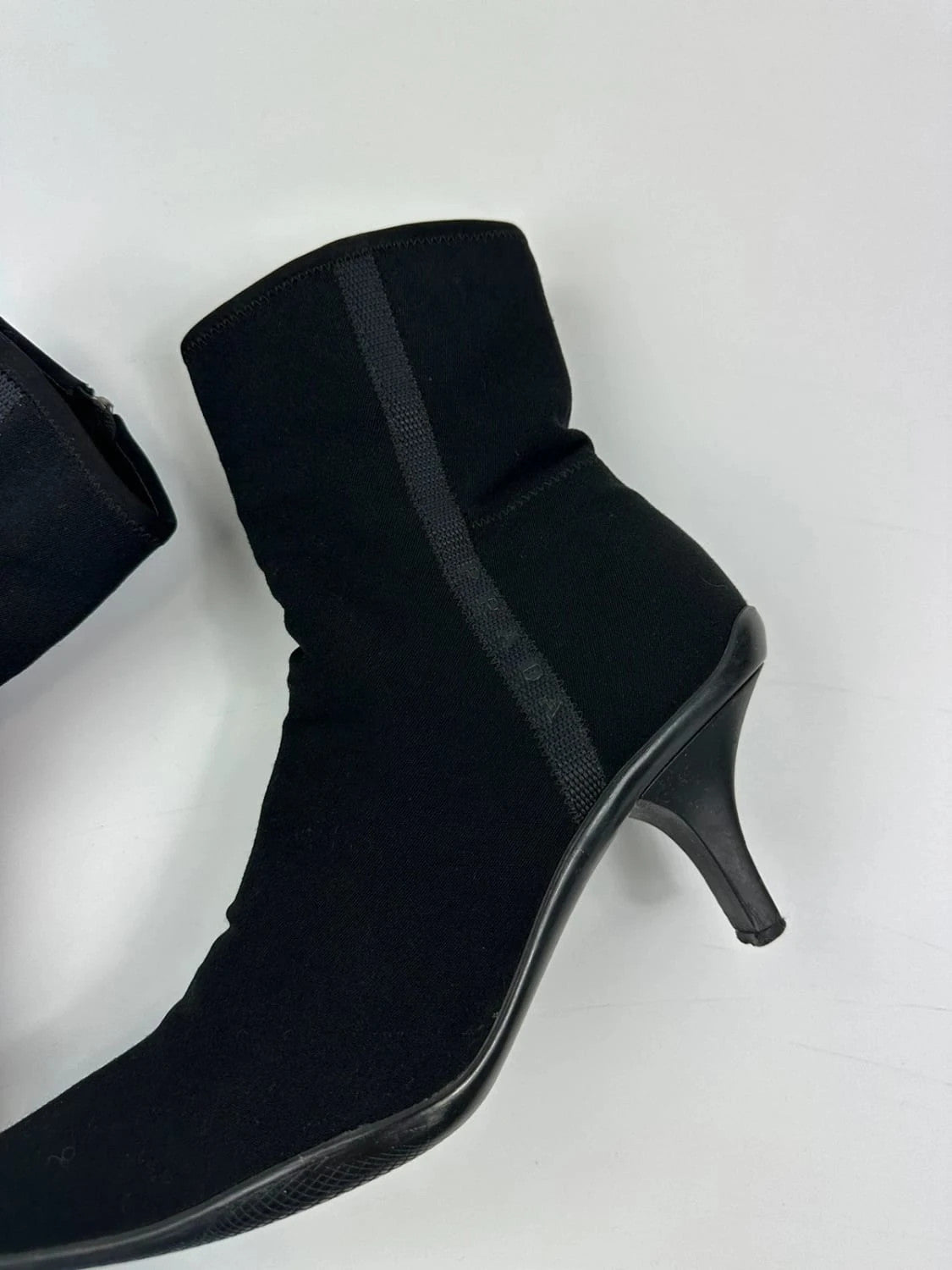 Prada black neoprene boots with pointed toe and leather interior.