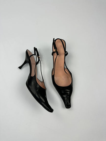 Prada black leather slingback mules with minimalist design and logo detail.