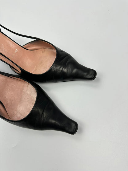 Prada black leather slingback mules with minimalist design and logo detail.