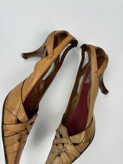 Prada beige leather pumps with pointy toe and subtle logo detailing.