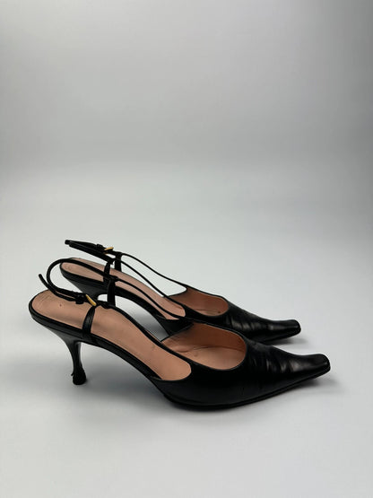 Prada black leather slingback mules with minimalist design and logo detail.