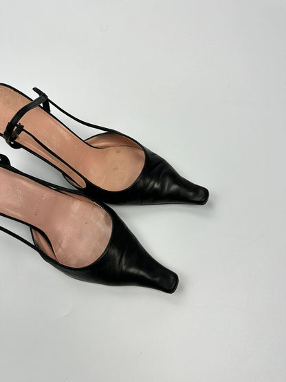 Prada black leather slingback mules with minimalist design and logo detail.
