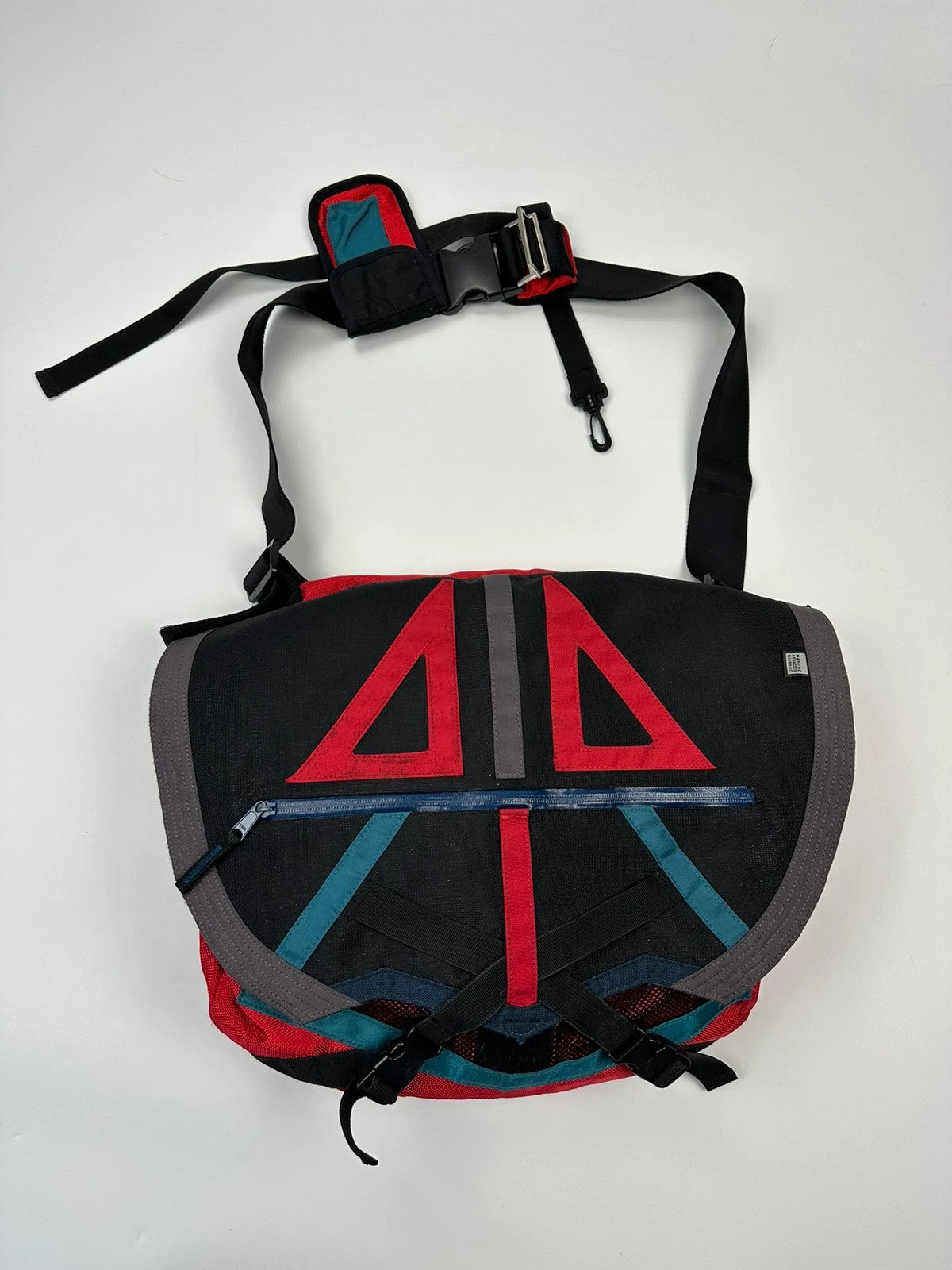 Marithé François Girbaud red and black messenger bag with mesh pocket and logo details.