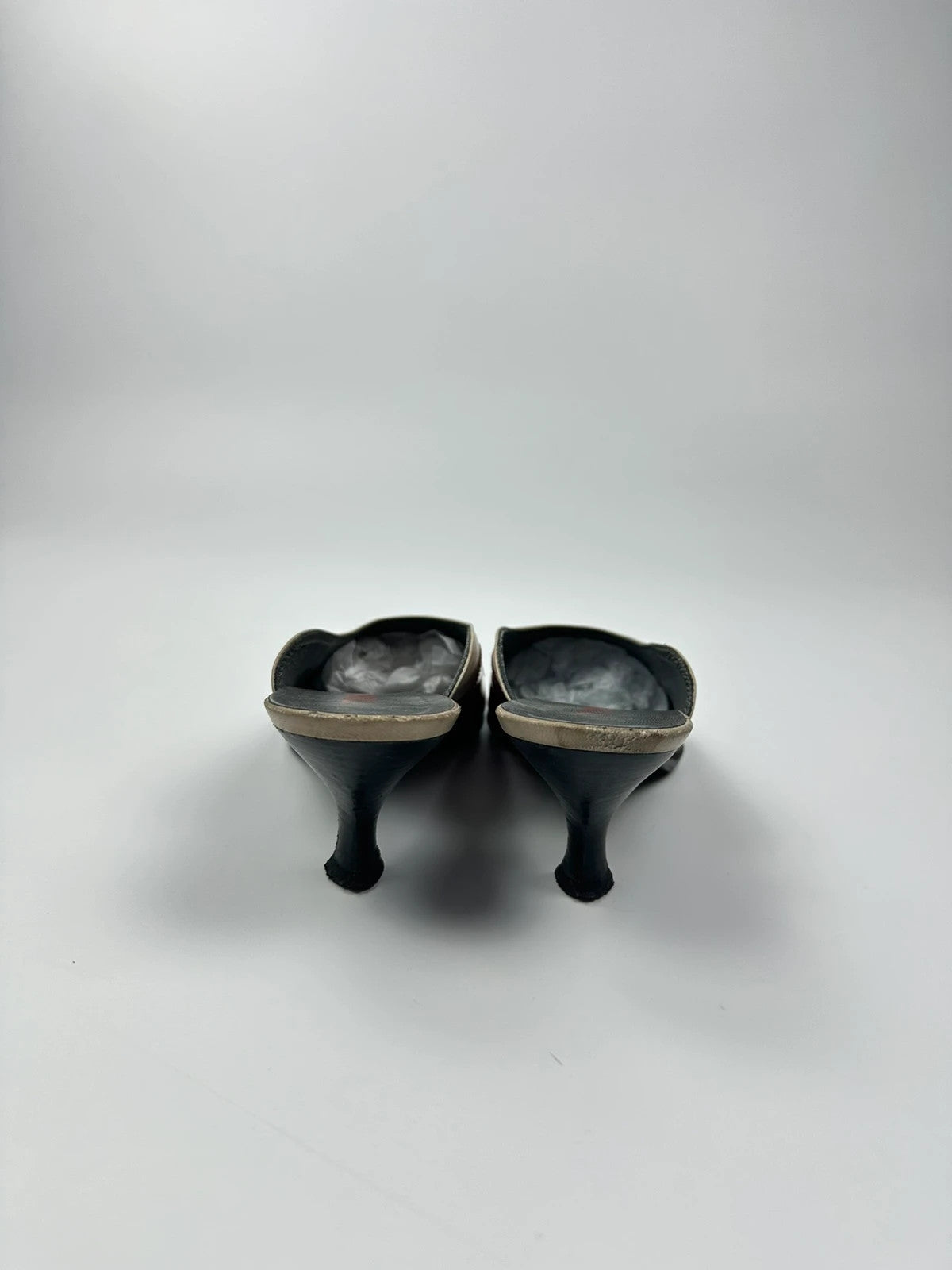 Miu Miu beige and red leather mules with kitten heels and minimalist design.