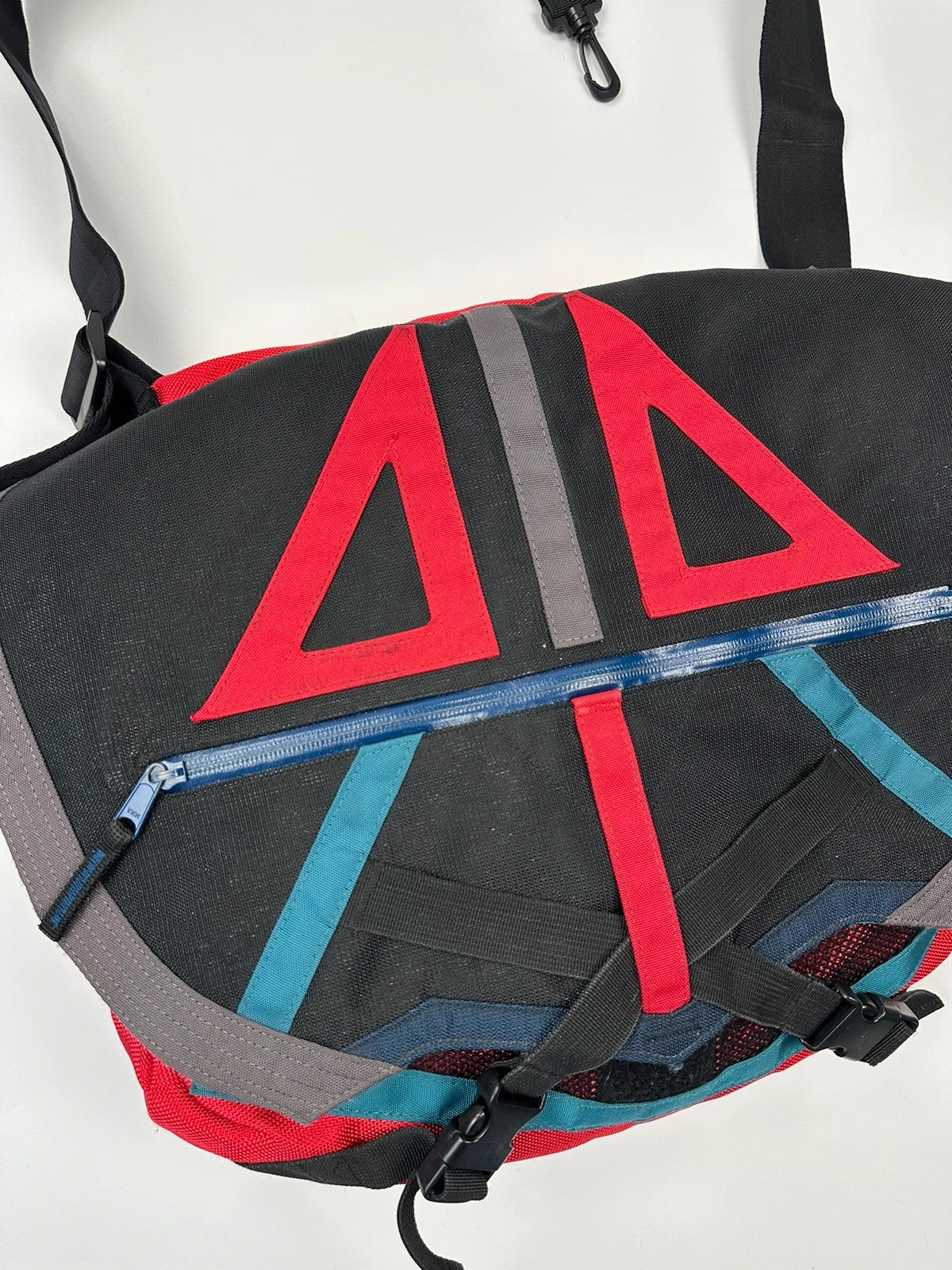 Marithé François Girbaud red and black messenger bag with mesh pocket and logo details.