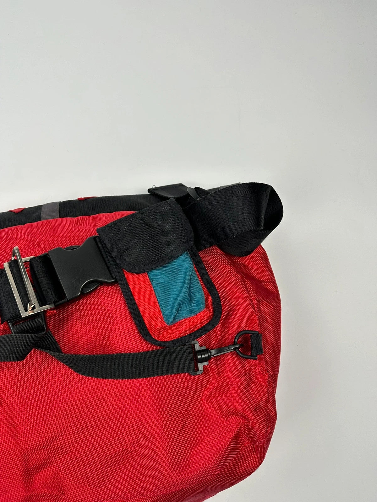 Marithé François Girbaud red and black messenger bag with mesh pocket and logo details.