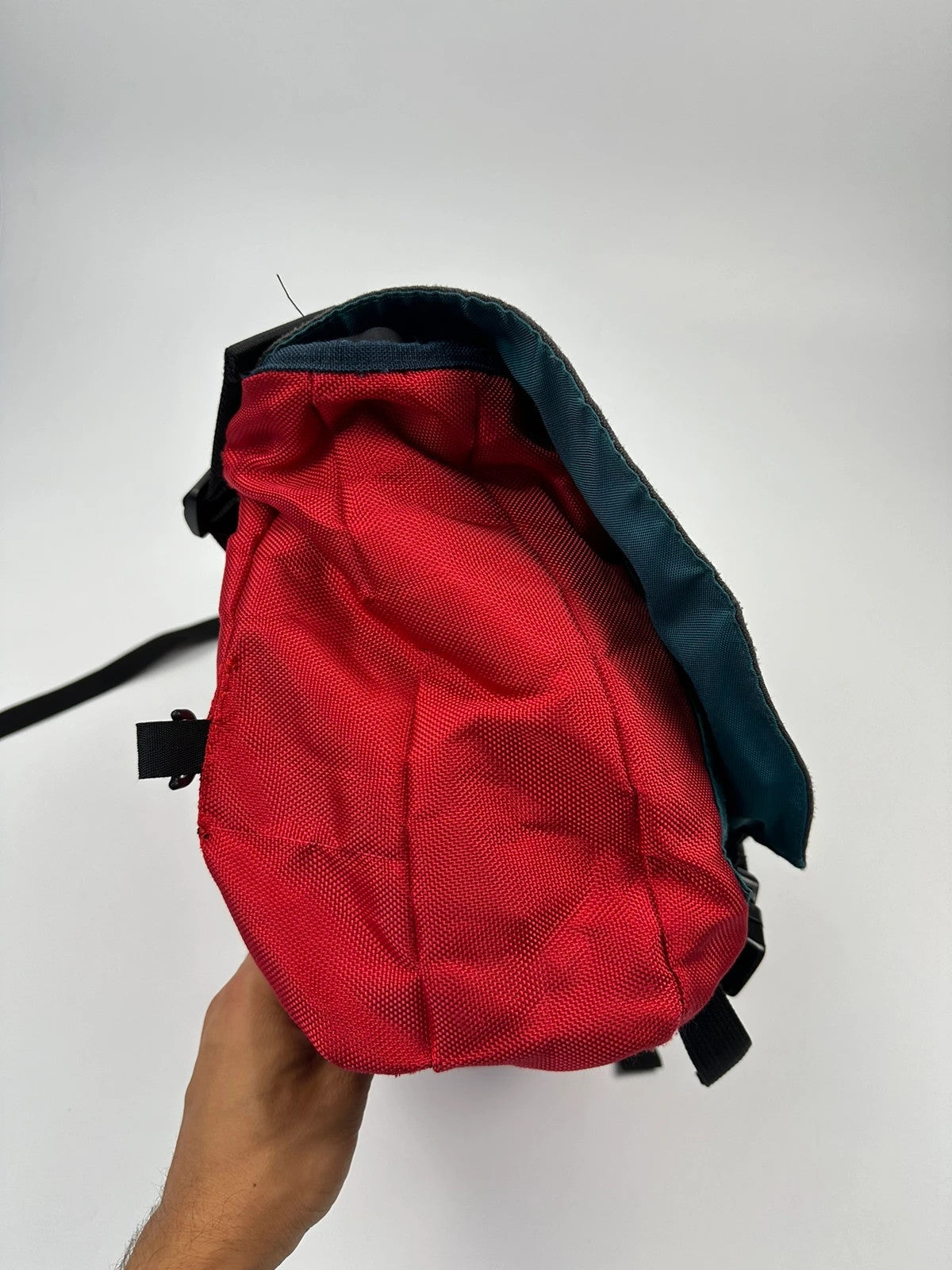 Marithé François Girbaud red and black messenger bag with mesh pocket and logo details.