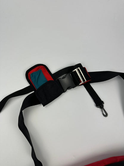 Marithé François Girbaud red and black messenger bag with mesh pocket and logo details.
