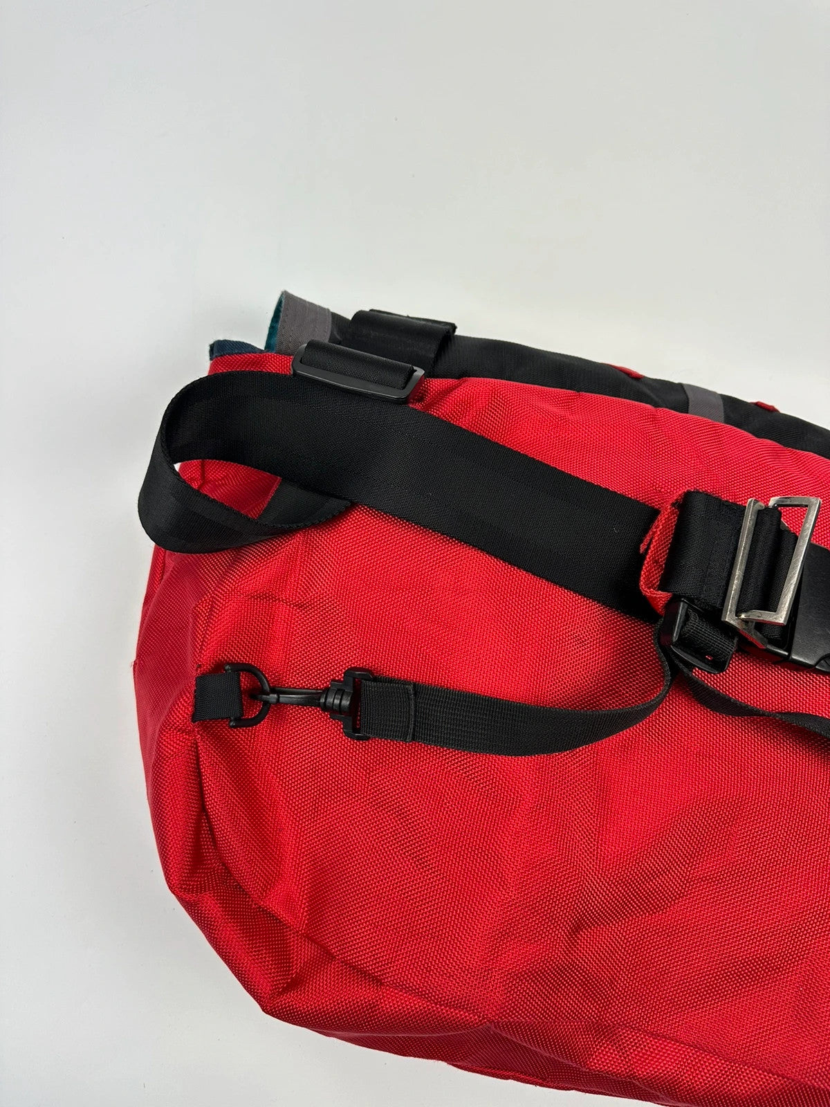 Marithé François Girbaud red and black messenger bag with mesh pocket and logo details.