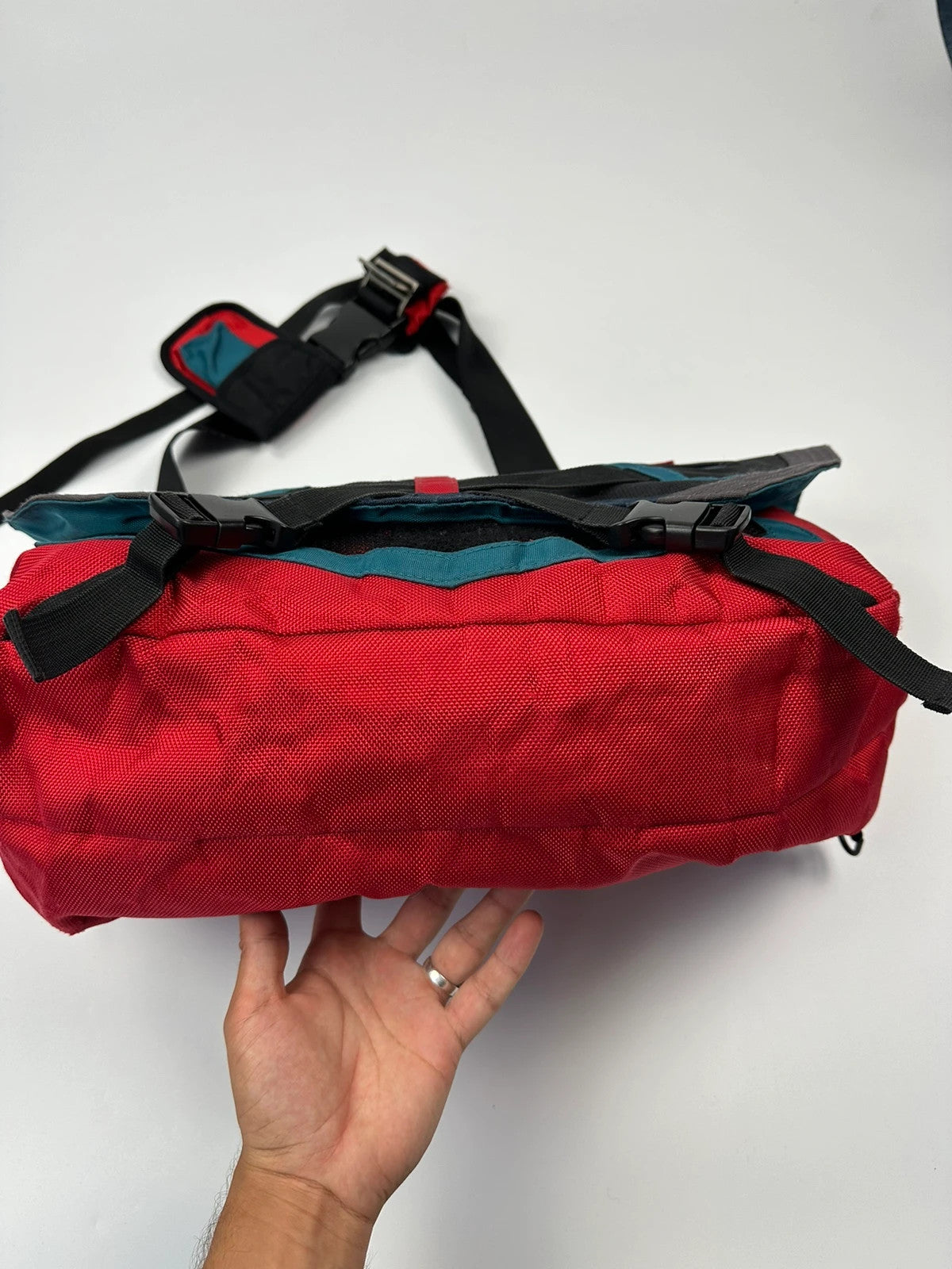 Marithé François Girbaud red and black messenger bag with mesh pocket and logo details.