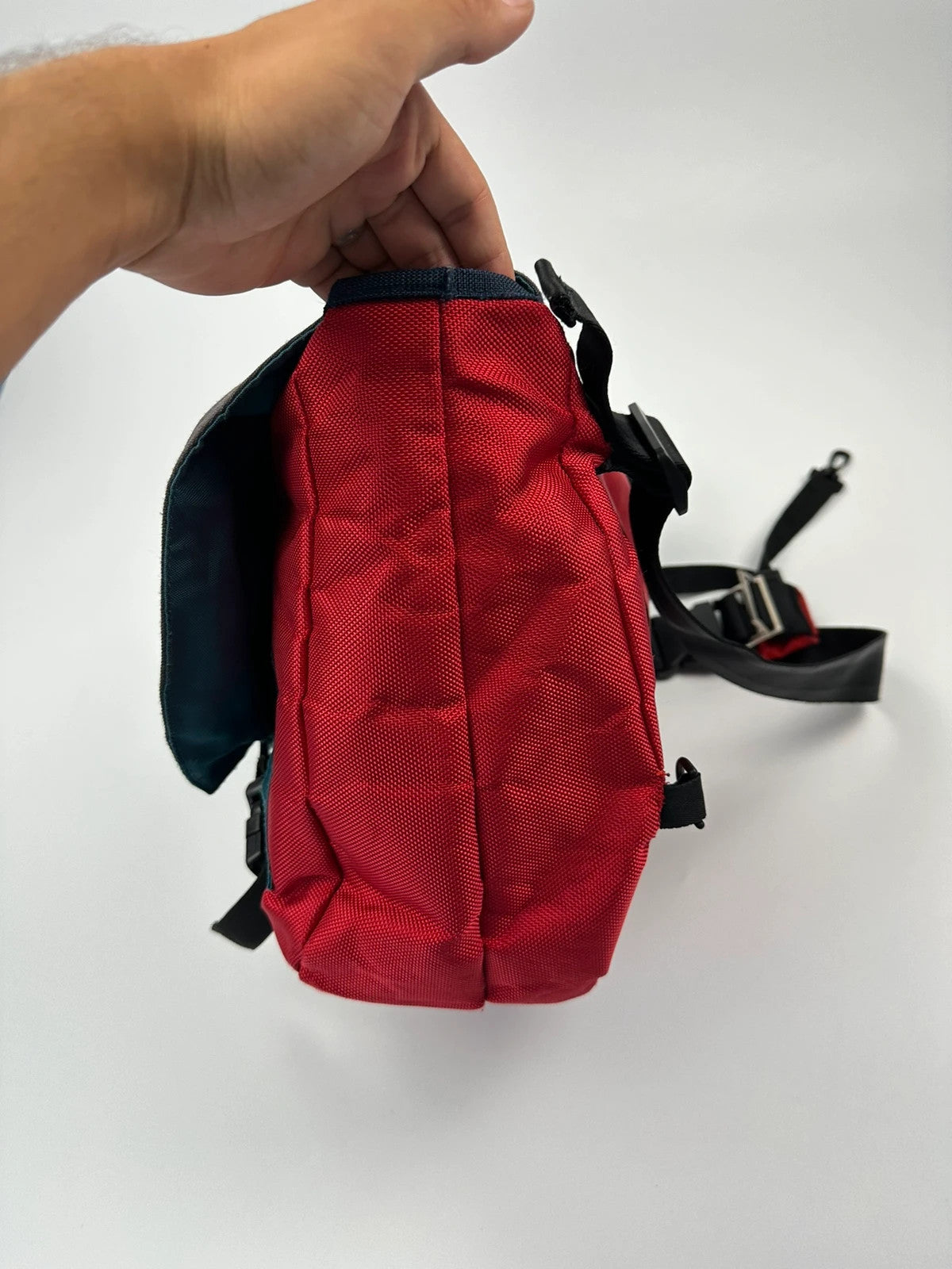Marithé François Girbaud red and black messenger bag with mesh pocket and logo details.