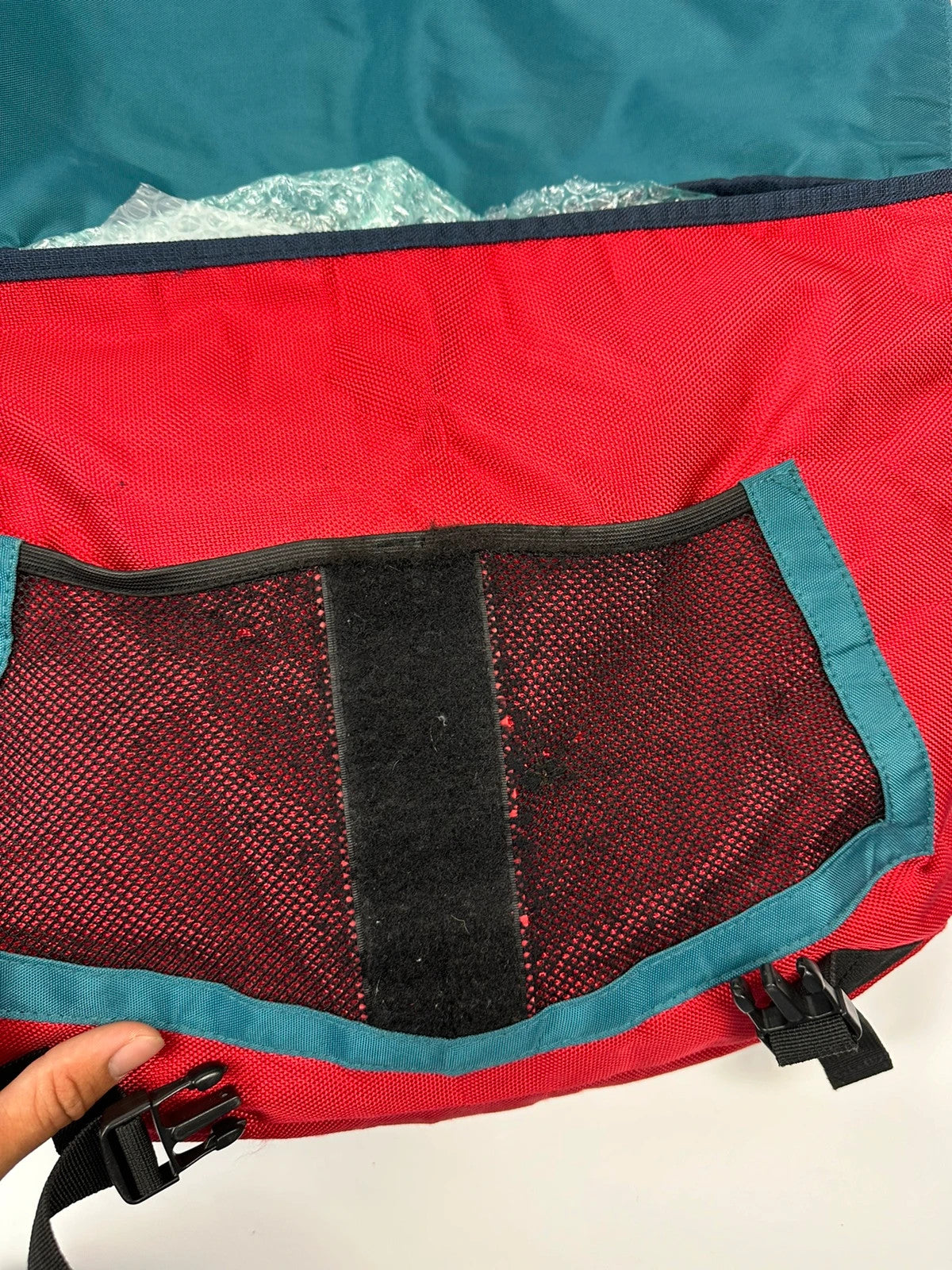 Marithé François Girbaud red and black messenger bag with mesh pocket and logo details.