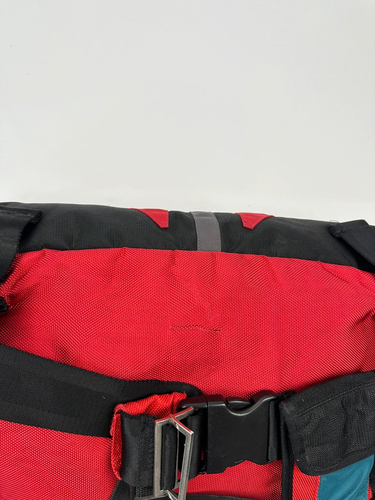 Marithé François Girbaud red and black messenger bag with mesh pocket and logo details.