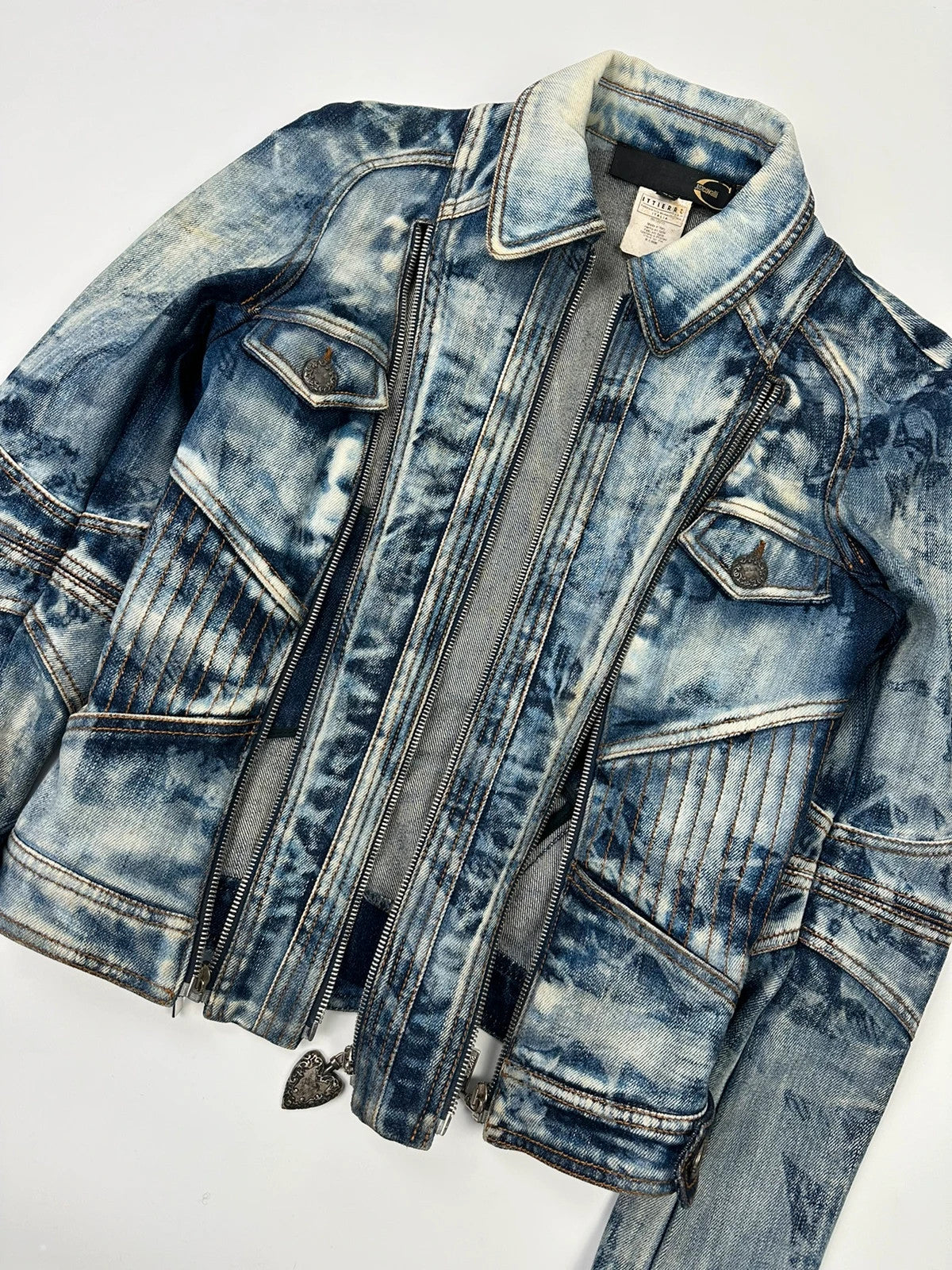 Just Cavalli sky blue denim jacket with multiple zippers and unique print design.