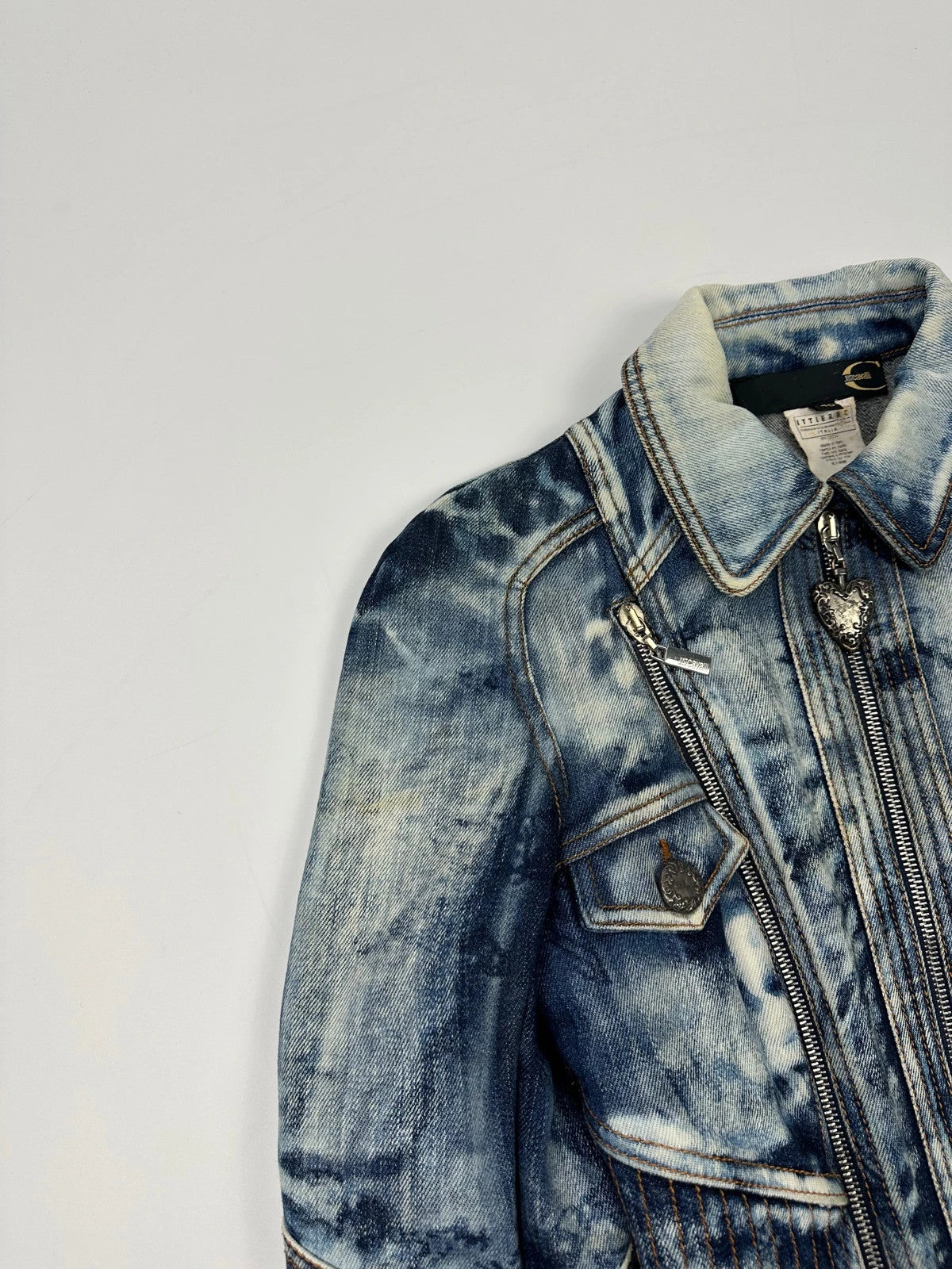Just Cavalli sky blue denim jacket with multiple zippers and unique print design.