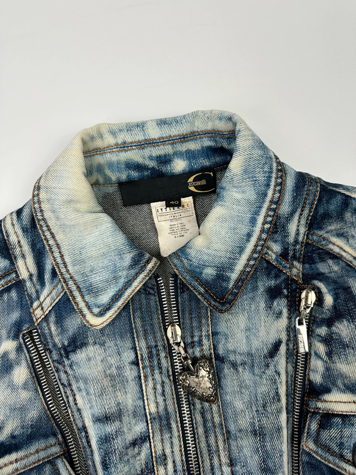 Just Cavalli sky blue denim jacket with multiple zippers and unique print design.