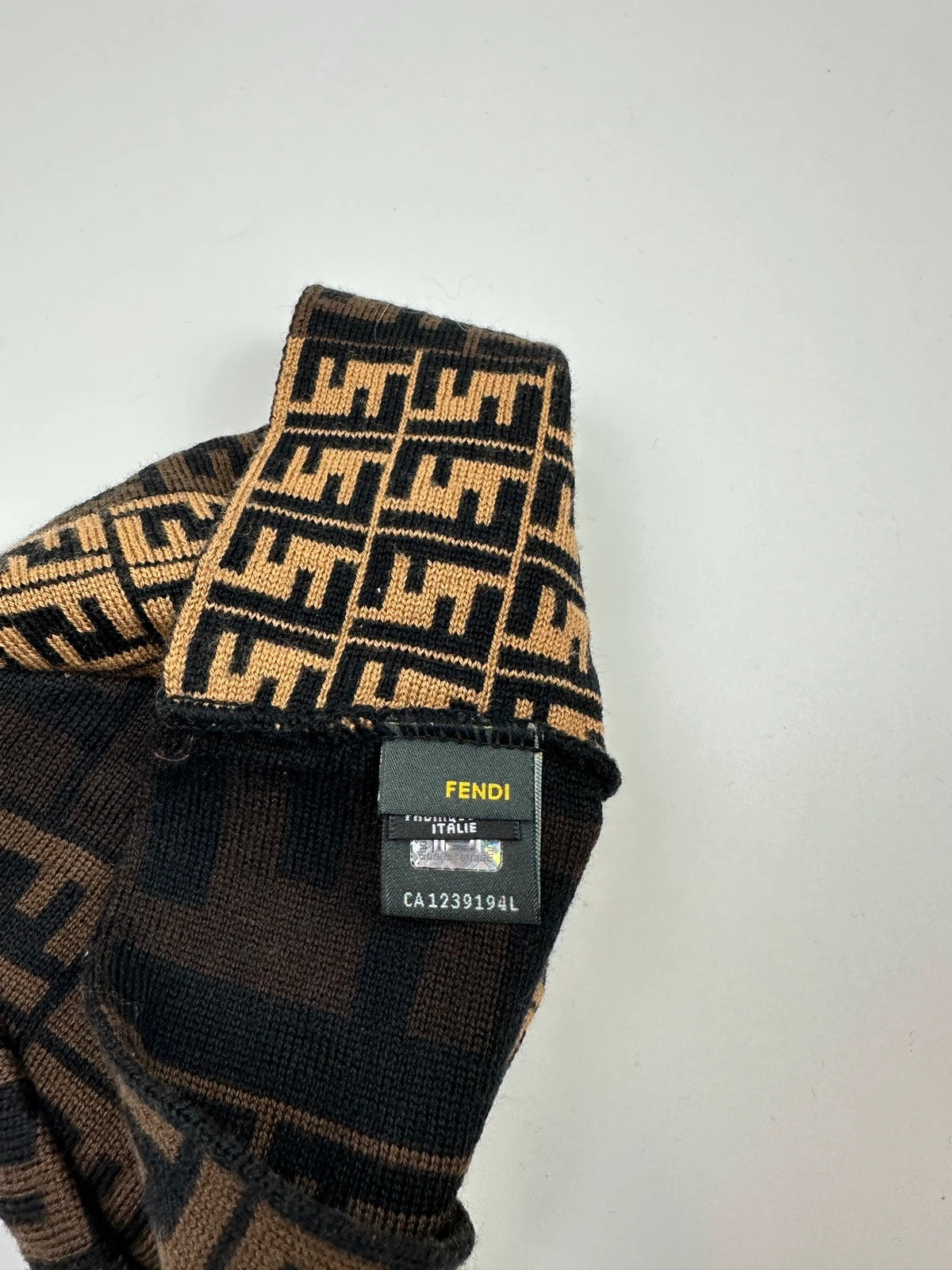 Fendi beige brown wool beanie with FF monogram pattern and vintage design.