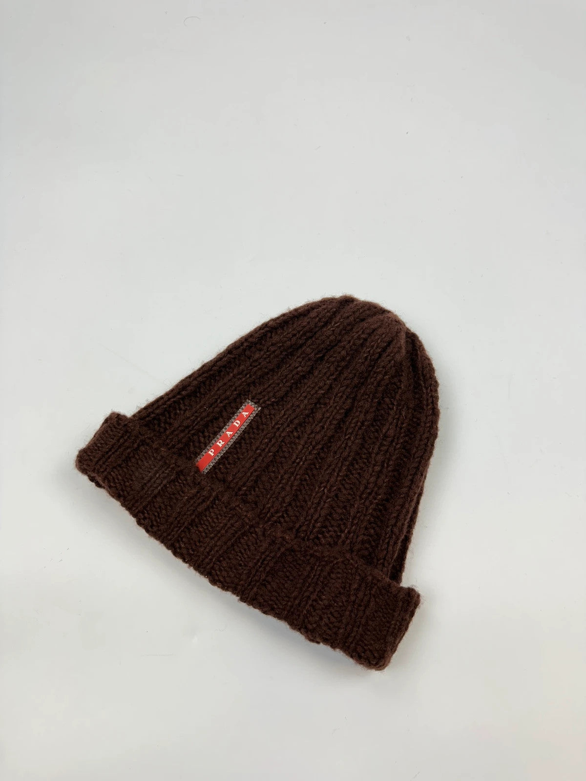 Prada brown wool knitted beanie with red logo tab from FW2014 collection.