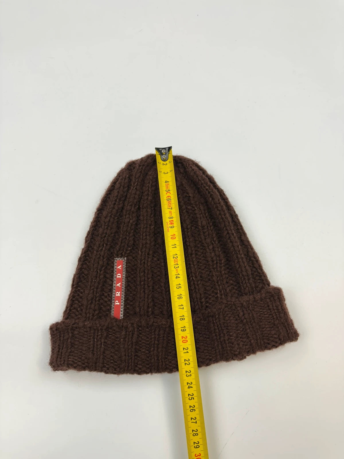 Prada brown wool knitted beanie with red logo tab from FW2014 collection.