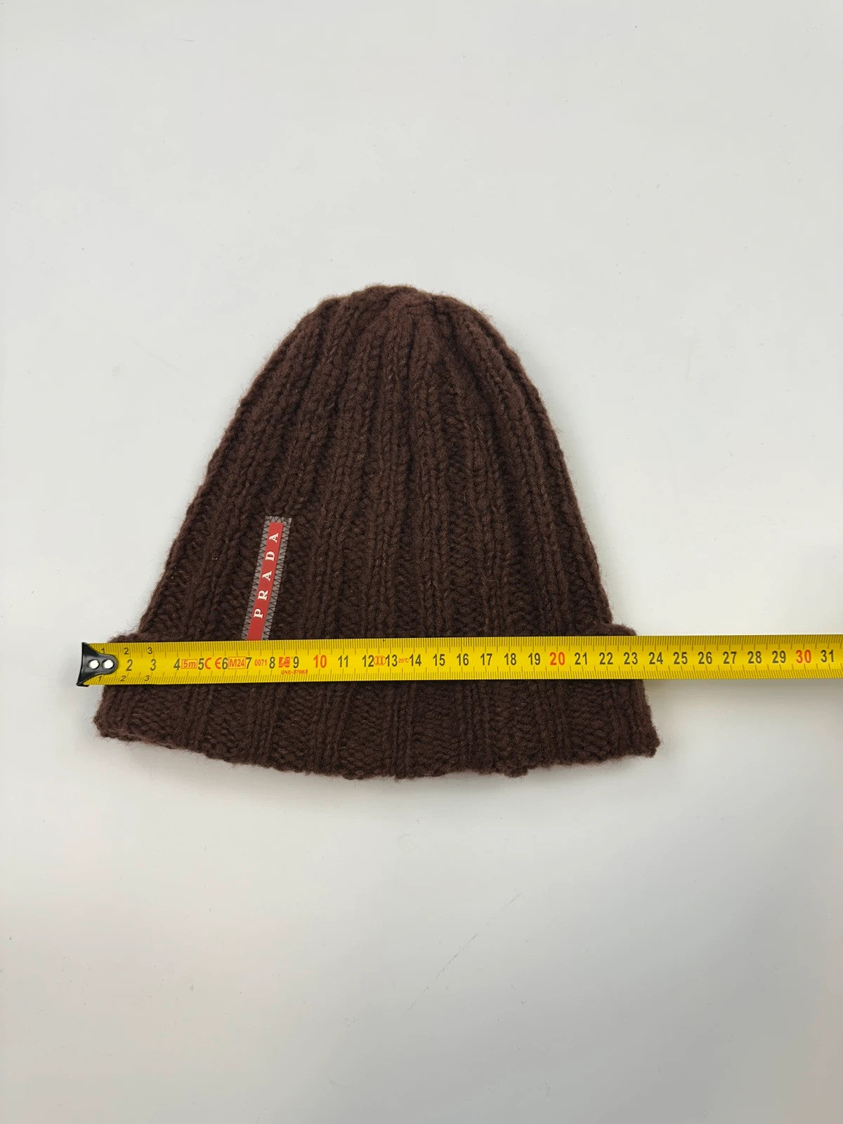 Prada brown wool knitted beanie with red logo tab from FW2014 collection.