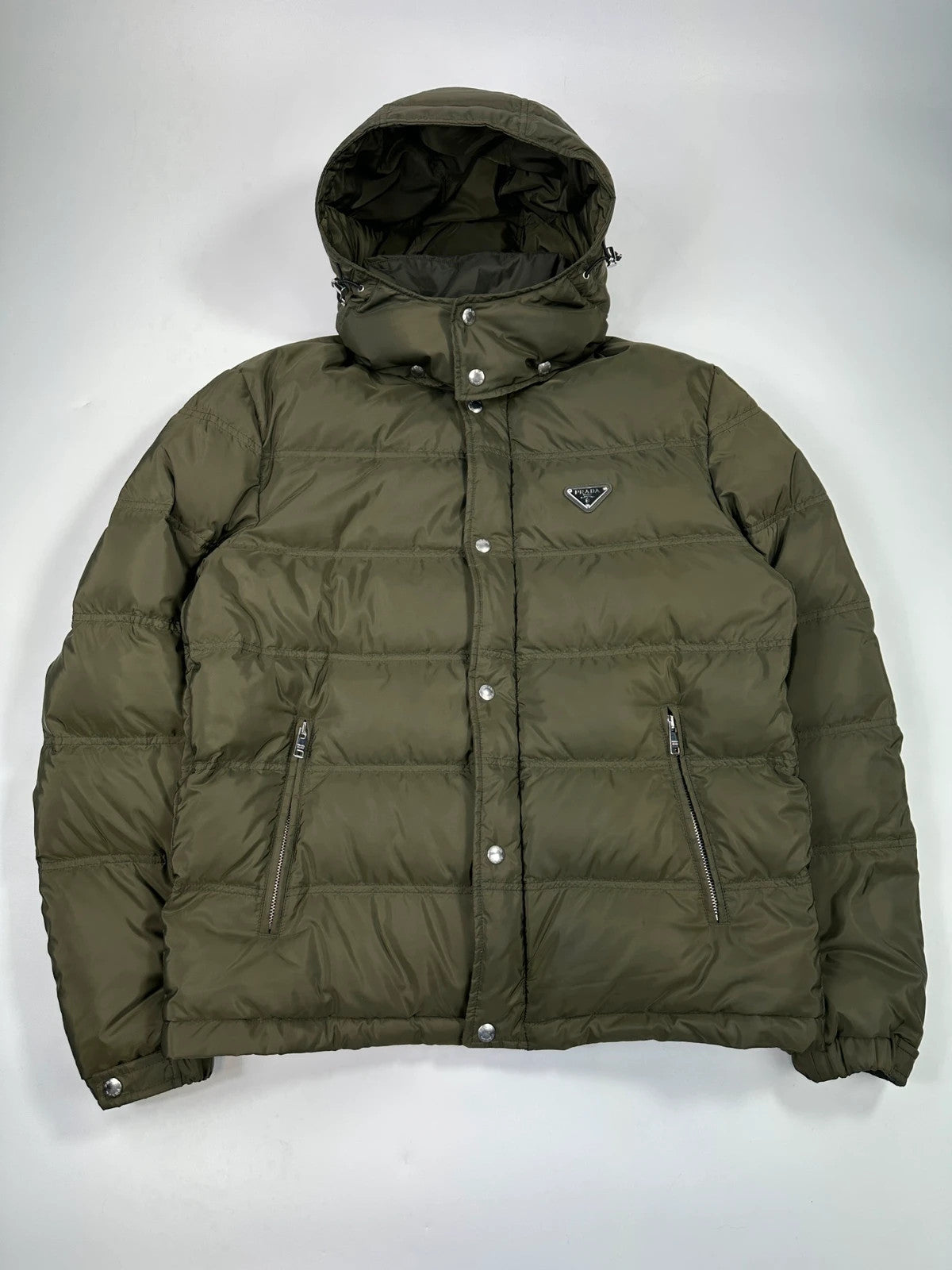 Prada khaki puffer down jacket with hood, featuring triangle logo and luxurious material.