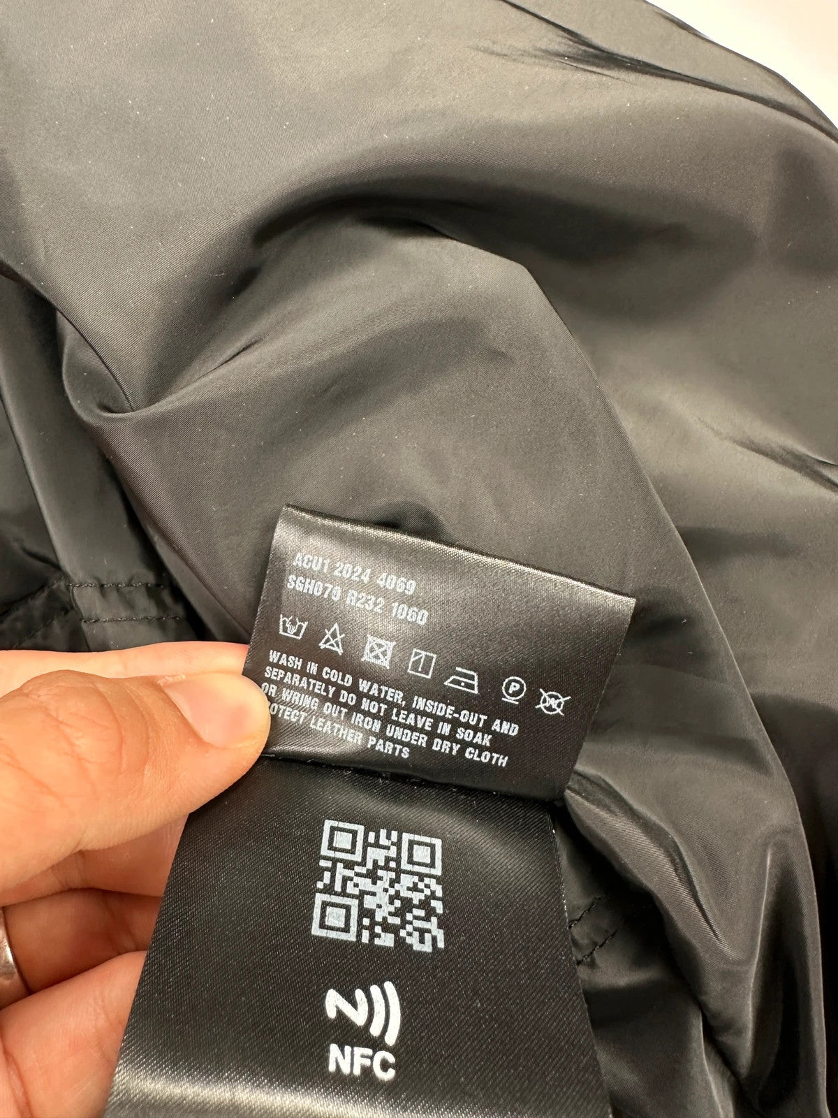 Prada khaki puffer down jacket with hood, featuring triangle logo and luxurious material.