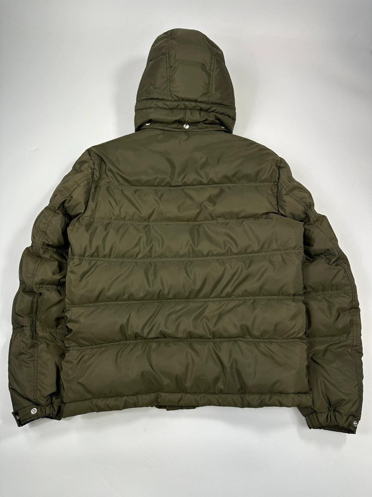Prada khaki puffer down jacket with hood, featuring triangle logo and luxurious material.