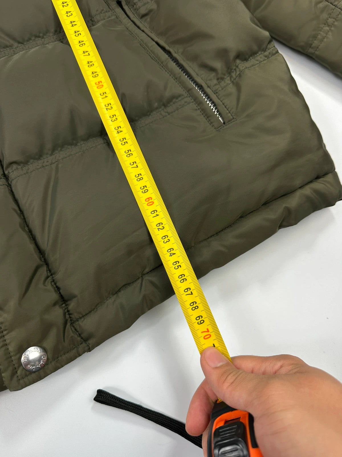 Prada khaki puffer down jacket with hood, featuring triangle logo and luxurious material.