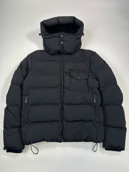 Prada dark navy hooded puffer jacket with triangle logo and vintage 2000s design.