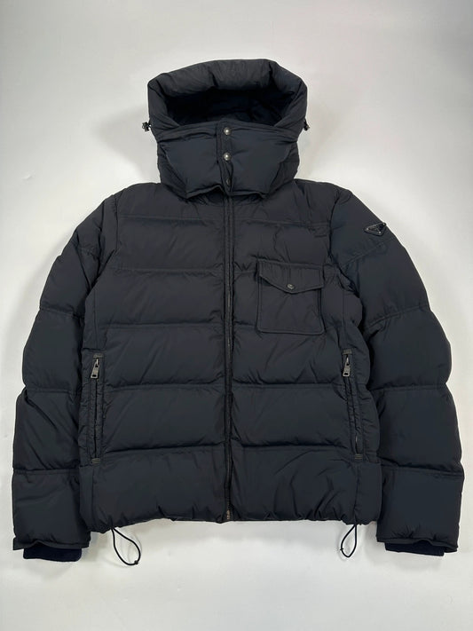 Prada dark navy hooded puffer jacket with triangle logo and vintage 2000s design.