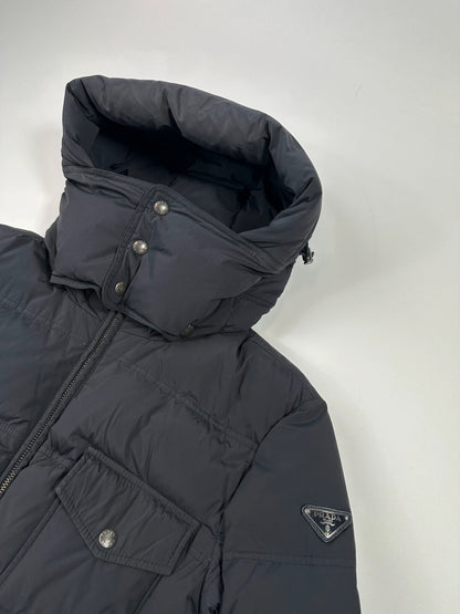 Prada dark navy hooded puffer jacket with triangle logo and vintage 2000s design.