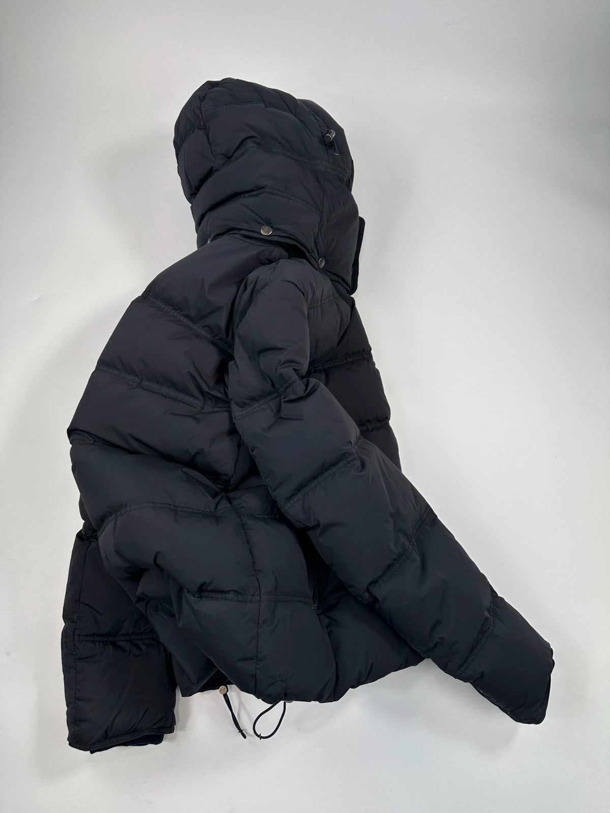Prada dark navy hooded puffer jacket with triangle logo and vintage 2000s design.