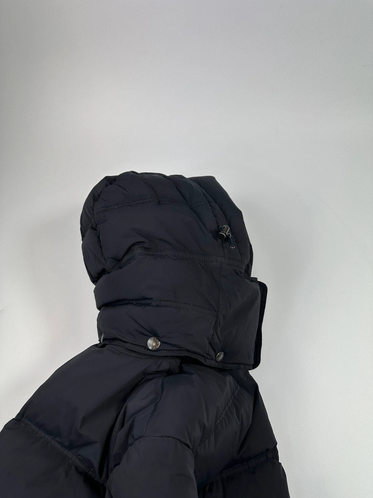 Prada dark navy hooded puffer jacket with triangle logo and vintage 2000s design.