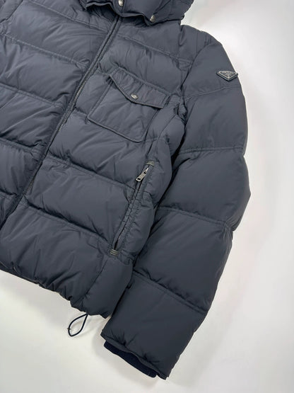 Prada dark navy hooded puffer jacket with triangle logo and vintage 2000s design.