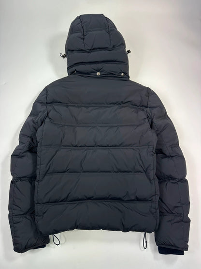 Prada dark navy hooded puffer jacket with triangle logo and vintage 2000s design.