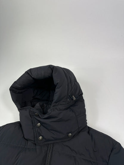 Prada dark navy hooded puffer jacket with triangle logo and vintage 2000s design.