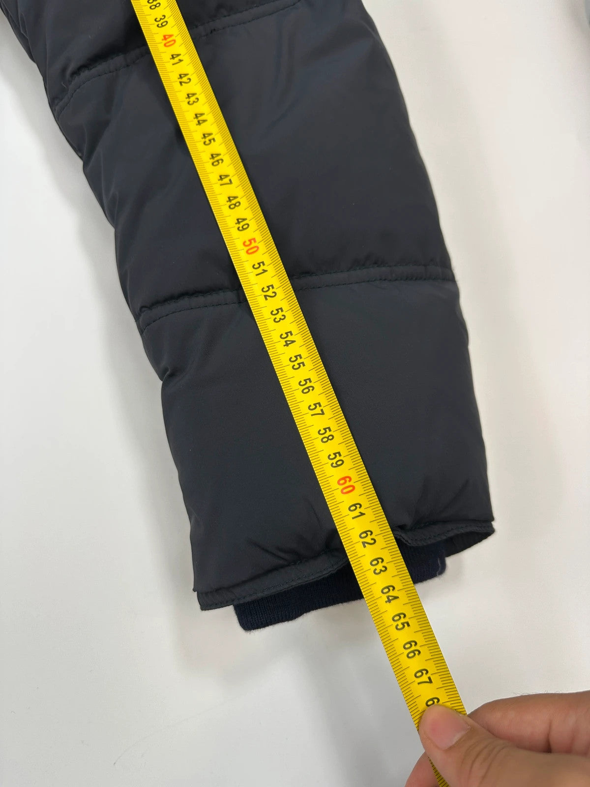 Prada dark navy hooded puffer jacket with triangle logo and vintage 2000s design.