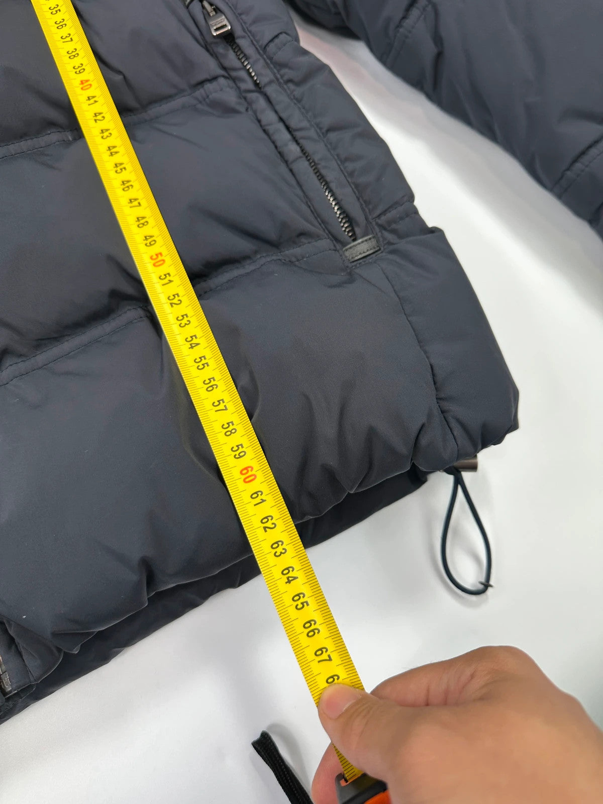 Prada dark navy hooded puffer jacket with triangle logo and vintage 2000s design.