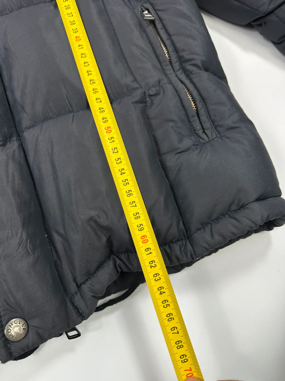Moncler navy blue puffer jacket with French logo and hood, down-filled material.