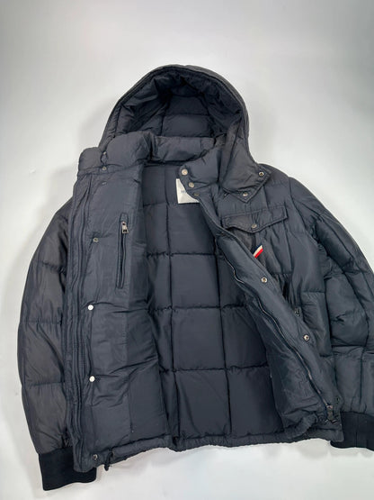 Moncler navy blue puffer jacket with French logo and hood, down-filled material.