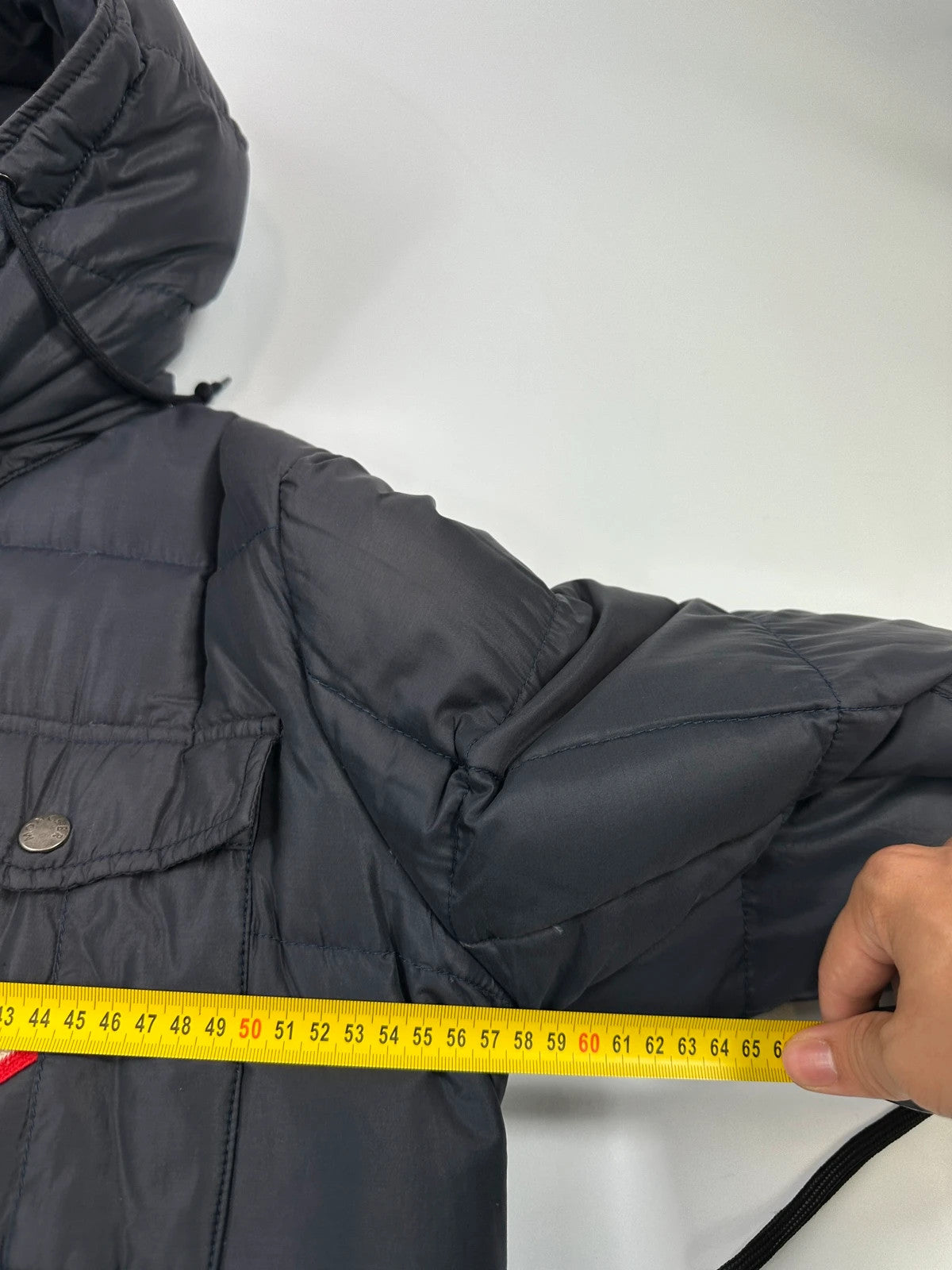 Moncler navy blue puffer jacket with French logo and hood, down-filled material.