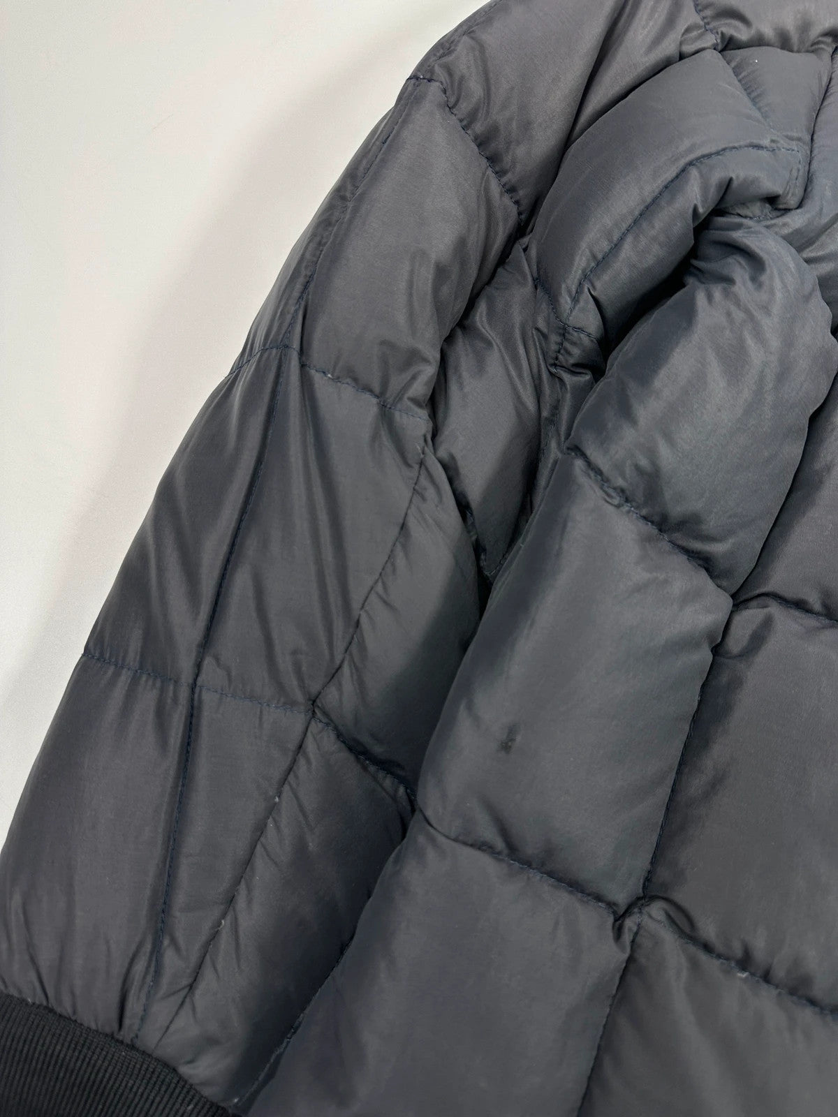 Moncler navy blue puffer jacket with French logo and hood, down-filled material.